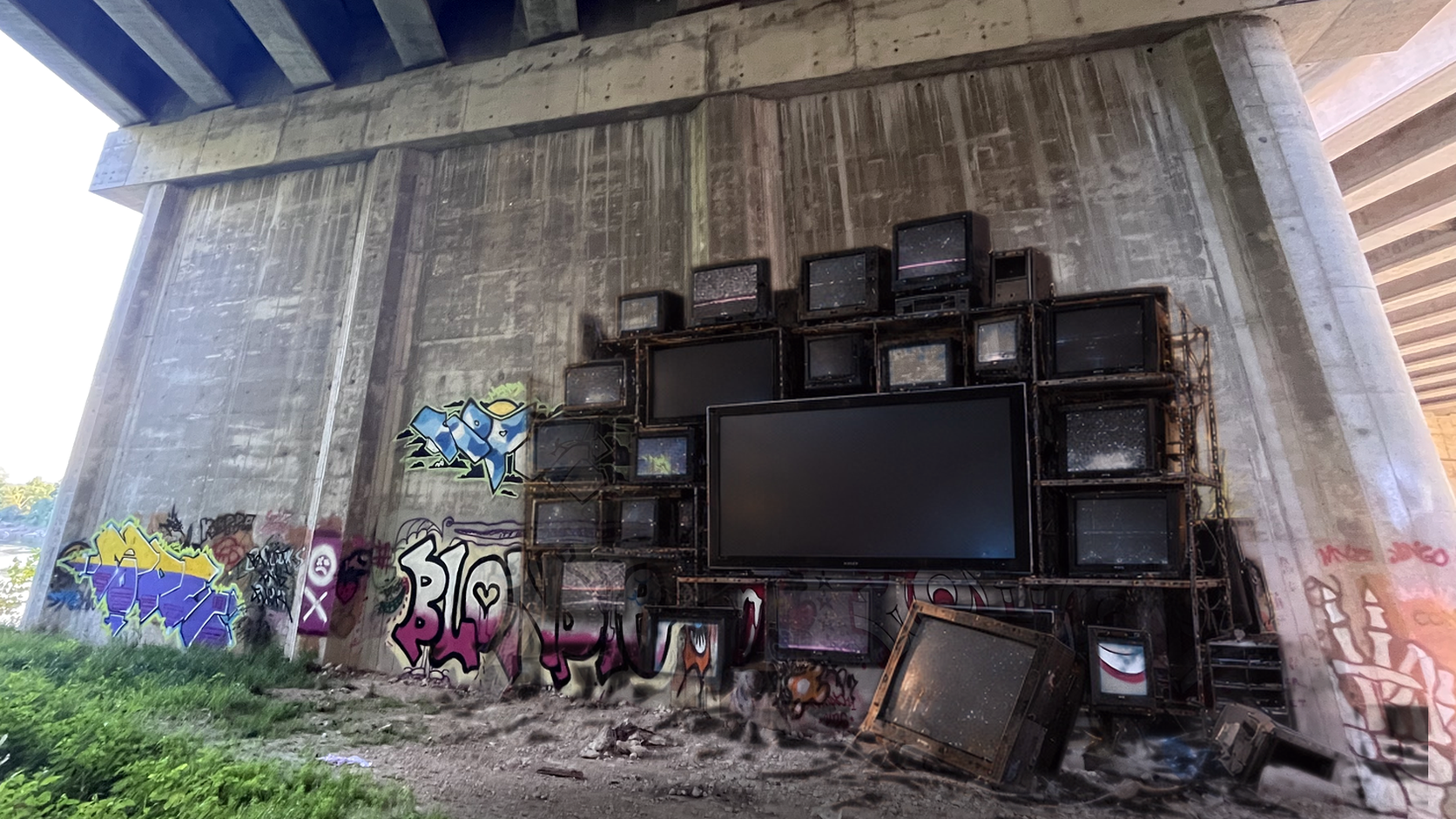 Watch room: a pile of CRT televisions in a graffiti underpass, where dreamUp videos play on the big glass